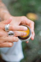Someone scooping Hera Tallow Balm from the jar 